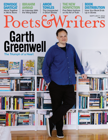 Garth Greenwell, a white man with brown hair, light skin, and blue eyes, stands in front of a waist-high set of shelves crammed full of books. He wears a dark blue long-sleeve button-up, black pants, and black shoes with white soles. The Poets & Writers logo is above him in orange, and various headlines in blue in green are at the top of the cover above the logo.